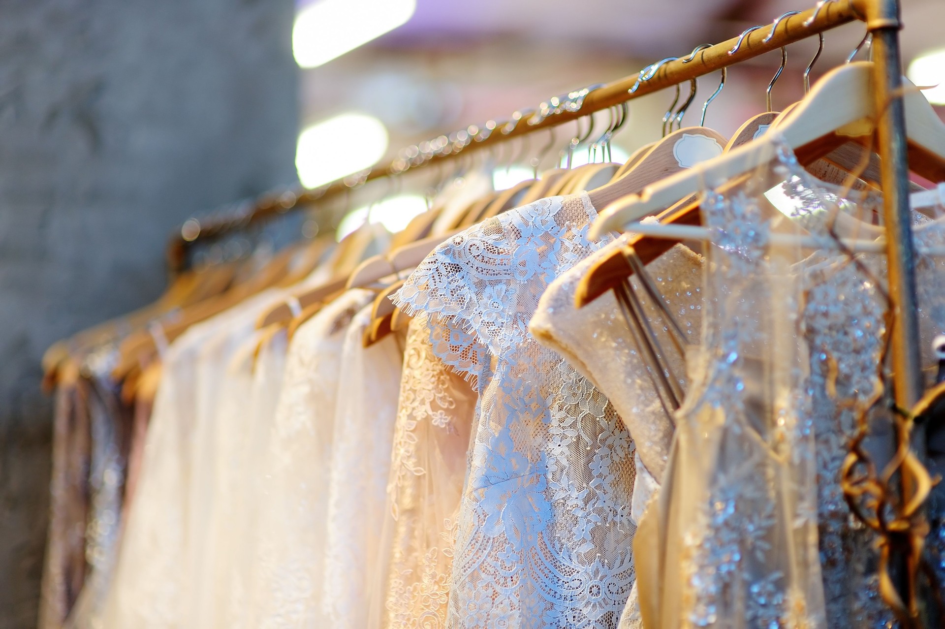A few beautiful wedding dresses on a hanger.