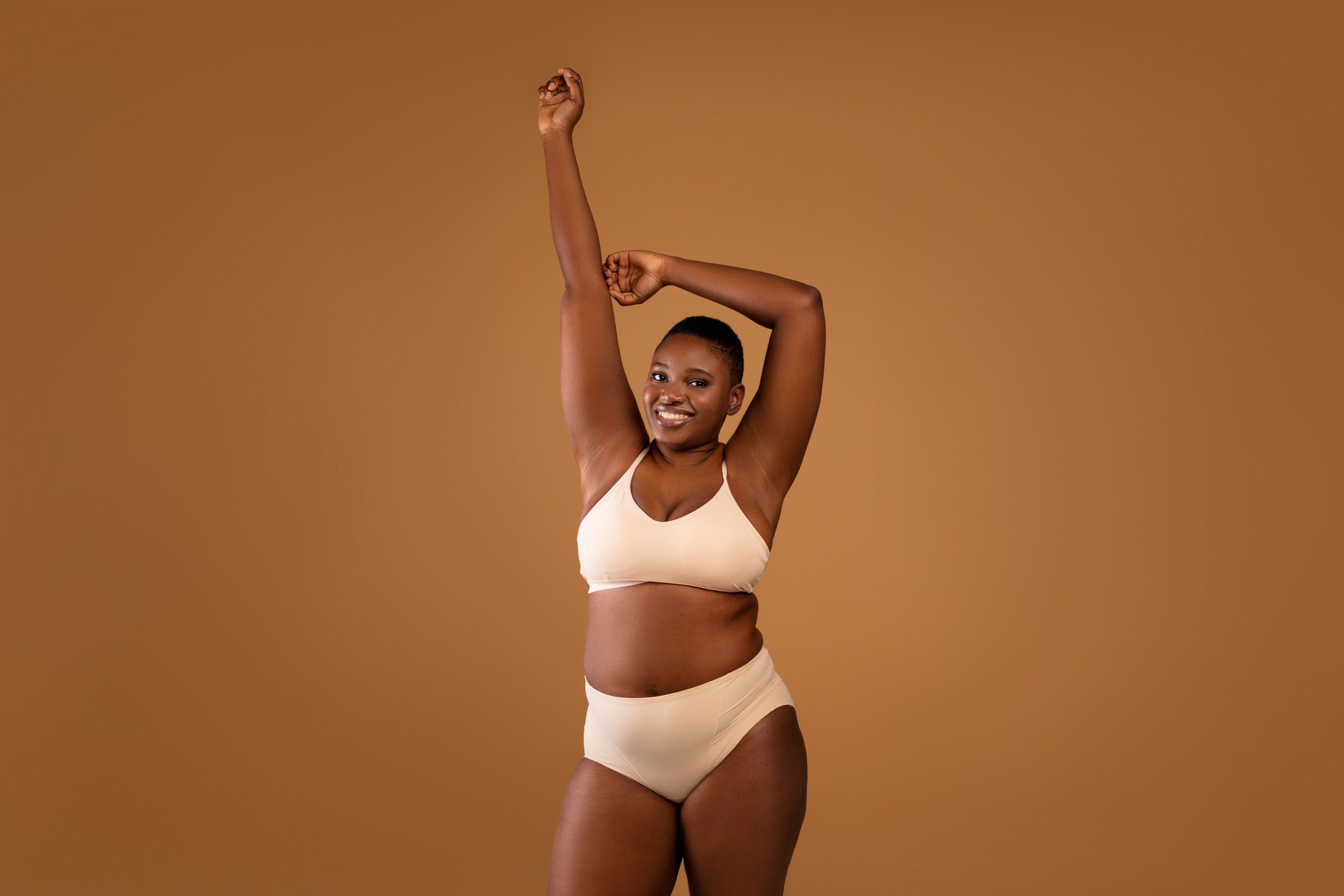 Portrait of beautiful plus size African american woman showing armpits