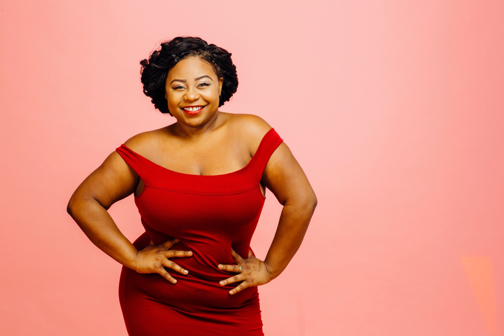 Confident in my body / Portrait of a happy, curvy young woman in red dress